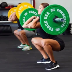 Bumper plates Force USA en caoutchouc colorés avec code couleur IWF de 5 à 25 kg